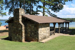 The Picnic Shelter at Van Pugh North Campground Lake Lanier is a great place to enjoy a meal with family and friends. The shelter is located in a beautiful setting on the shores of Lake Lanier. It has a large picnic table and benches, as well as a grill. There is also a playground nearby for the kids. The shelter is available for rent on a first-come, first-served basis.